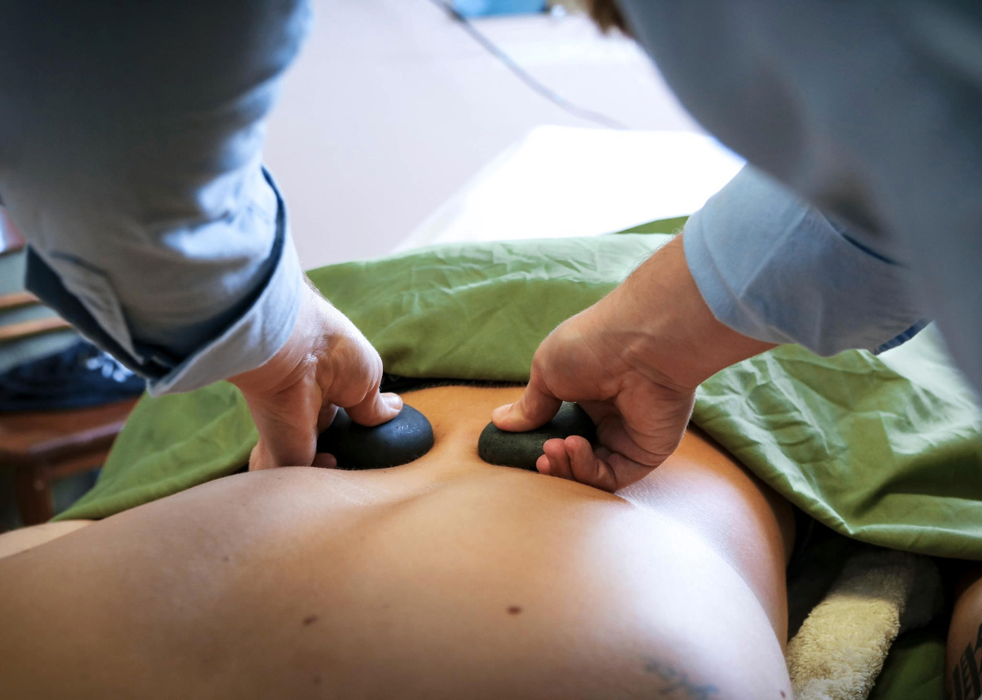 Hot stone massage in progress at A Time to Heal — heated basalt stones applied to the back